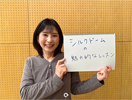 シルクドームの魅力的なレッスンと書かれたスケッチブックを持った女性
